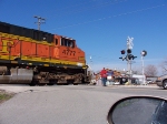 Conductor walks BNSF 4777 across the road.